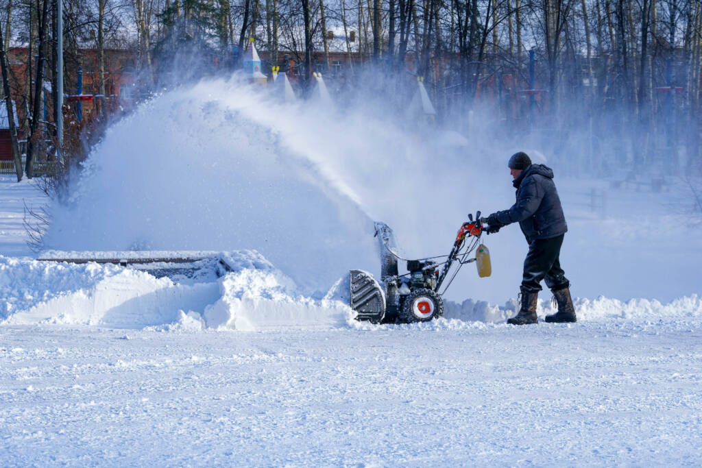 CrystalCrest Inc employee efficiently operating a snow removal machine to clear pathways and ensure safe, accessible surroundings.