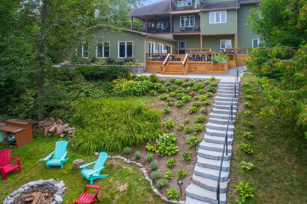 Beautifully renovated garden surrounding a backyard campfire site.